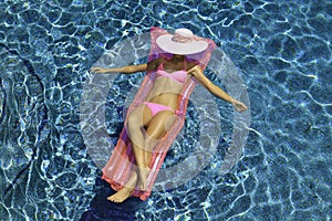 Woman in pink bikini floating