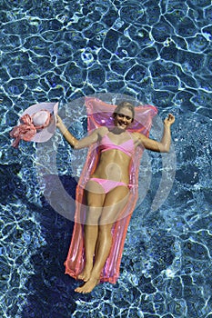 Woman in pink bikini floating
