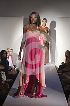 Woman In Pink Dress On Fashion Catwalk