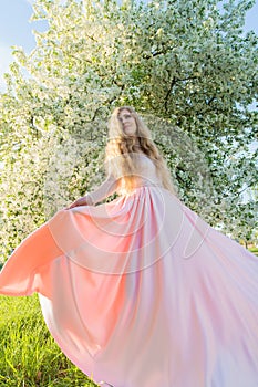 Woman in a pink dress in garden