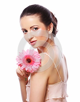 Woman with pink gerber flower isolated on white