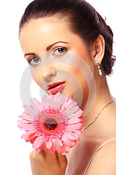 Woman with pink gerber flower isolated on white