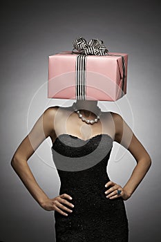 Woman with pink gift box on head