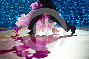 Woman in pink gown and man black tailcoat. Latino dancing