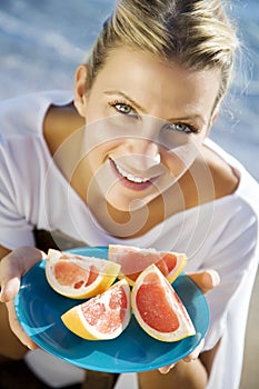 Woman with pink grapefruit