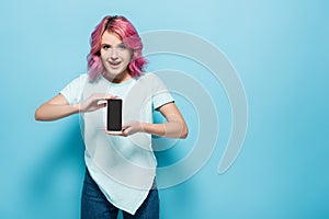 Woman with pink hair holding smartphone