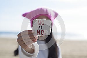 Woman with a pink hat and the text no is no