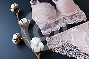 woman pink lace bra, panties lingerie with cotton buds on black. Shopping-fashion wardrobe concept