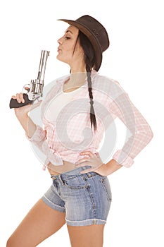 Woman pink plaid shirt gun blow