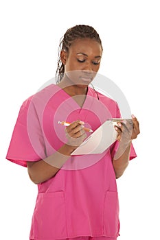 Woman pink scrubs writing down