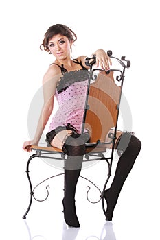 Woman in pink straddling a chair photo