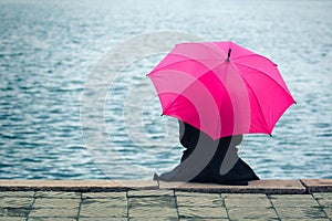 Woman with pink umbrella