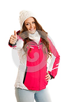 Woman in pink winter jacket ishowing thumb up solated over white