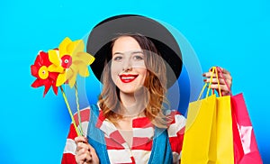 Woman with pinwheel and shopping bags