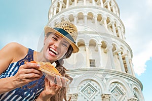 Woman with pizza in front of leaning tower of pisa