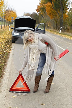 Woman places an emergency sign