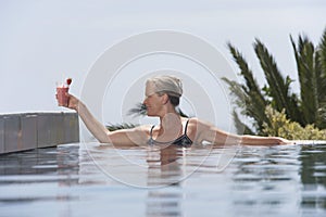 Woman Placing Daiquiri On Poolside