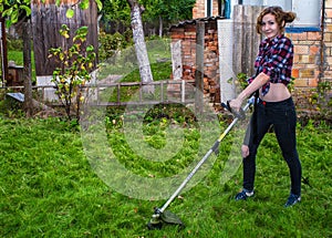 Woman in Plaid Shirt Mowing Lawn