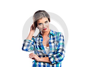 Woman with plait in blue and green checked shirt smiling