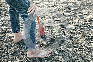 Woman planted a tree on a drought-stricken land.