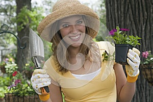 Woman planting flowers in her garden