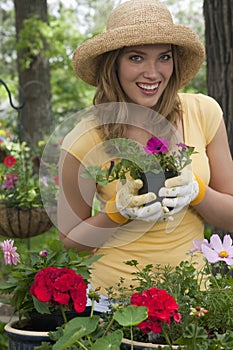 Woman planting flowers in her garden