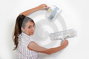 Woman plastering the wall