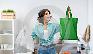 Woman with plastic and reusable shopping bag