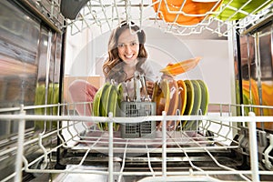 Woman With Plate View From Inside The Dishwasher photo
