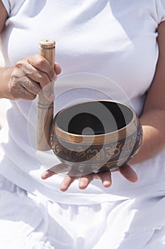 Woman play a cuenco on the beach photo