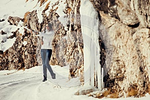 Woman play with ice and snow in mountains