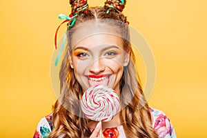 Woman with playful look lick candy with tongue