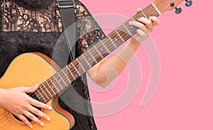 A woman playing acoustic guitar by chord C