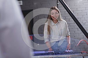 Woman playing on air hockey table