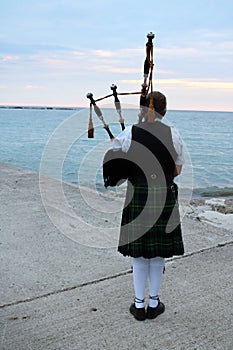 Woman playing the Bagpipes at Lake Huron in Kincardine