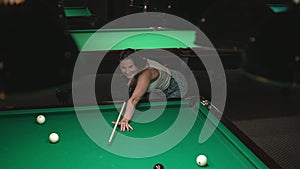 woman playing billiards