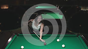 woman playing billiards