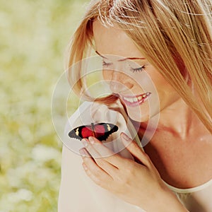 Woman playing with a butterfly