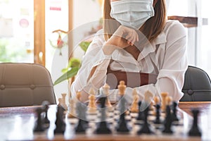 Woman playing chess in club