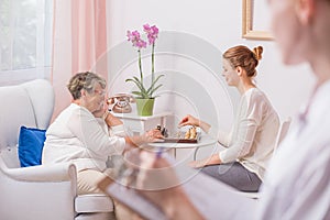 Woman playing chess with mother