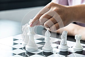 Woman playing chess and thinking strategy plan about crash overthrow the opposite team and development analyze for successful