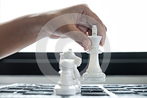 Woman playing chess and thinking strategy plan about crash overthrow the opposite team and development analyze for successful