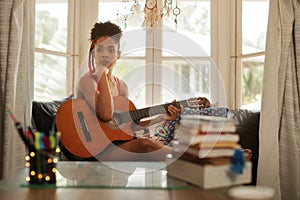 Woman Playing Classic Guitar Composing Music In Her Room