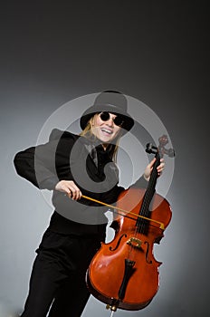 The woman playing classical cello in music concept