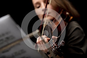 Woman playing a classical violin during a recital