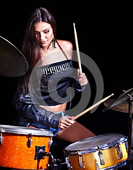 Woman playing drum and cymbals. photo