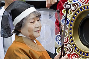 Woman playing the drum at the Takayama festival, Japan