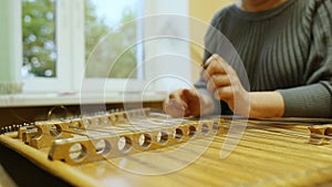 Woman playing the dulcimer in the College of Music