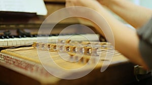 Woman playing the dulcimer in the College of Music