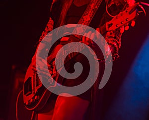 Woman playing electric guitar on stage